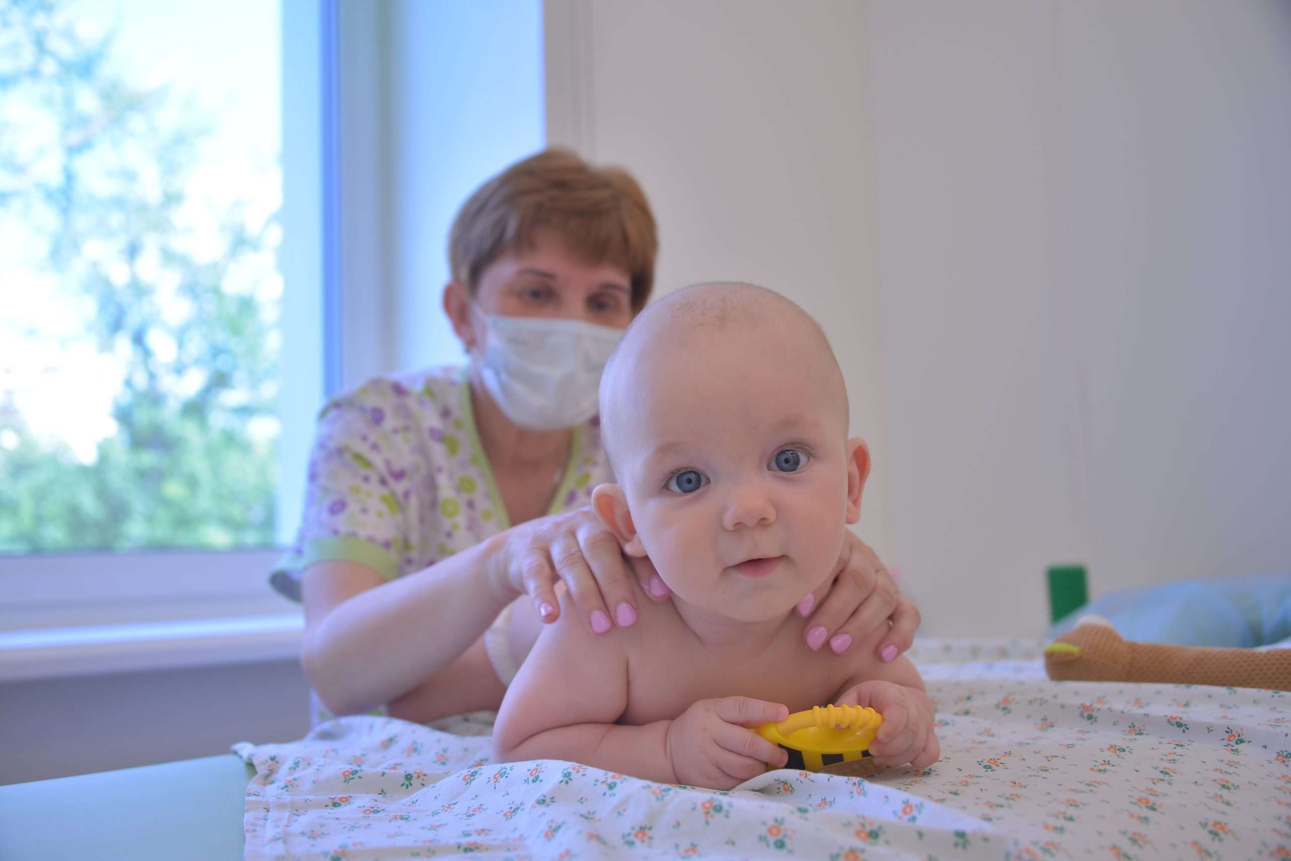 14 июня 2022 года. В обновленной детской поликлинике № 104 врач Маргарита Волощук делает лечебный массаж маленькому пациенту Луке Егорову. Фото: Анна Малакмадзе